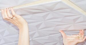 2 Close up of person installing a ceiling tile