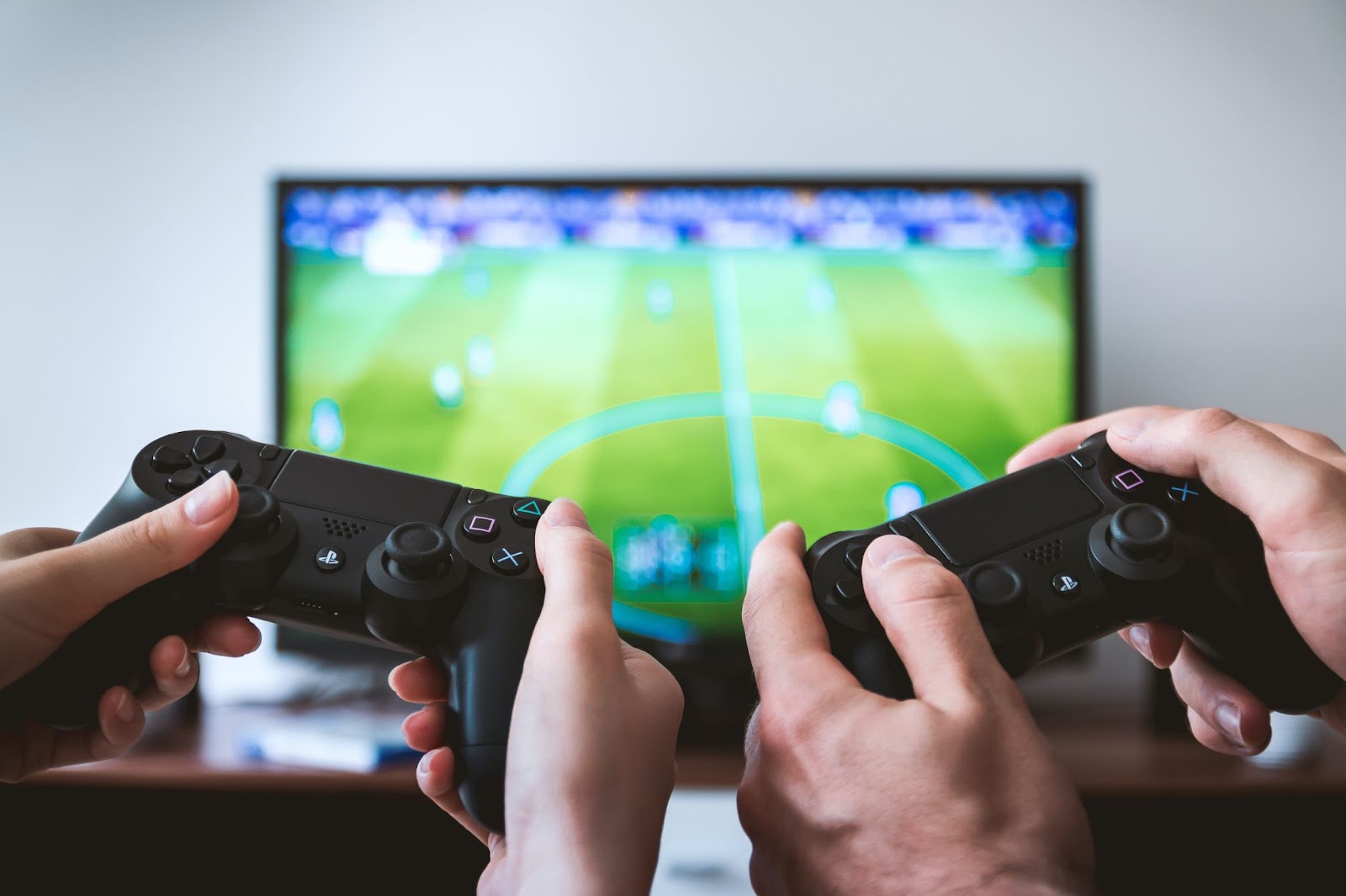play station controller with fifa in the background